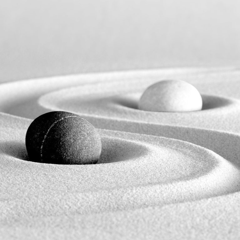 Two pebbles separated by sand representing divorce & separation